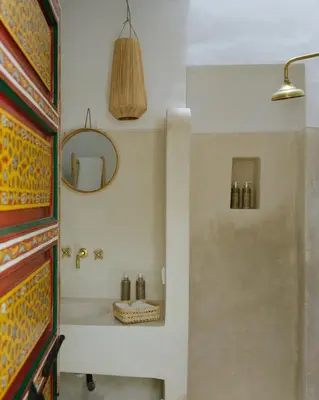 a bathroom with a sink and a mirror at Riad dar Maloukti in Marrakech