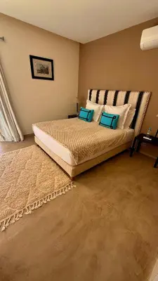 a bedroom with a large bed with blue pillows at CASA EDEN - Serenity and elegance between Atlas mountains and city center in Marrakech