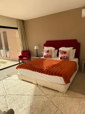 a bedroom with a large bed with a red headboard at CASA EDEN - Serenity and elegance between Atlas mountains and city center in Marrakech