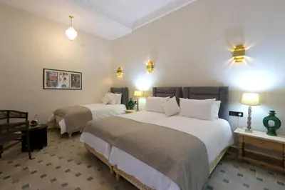 a hotel room with two beds and two lamps at riad NAMLA in Marrakech