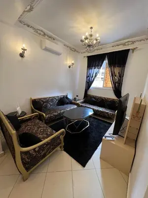 a living room with couches and a table at إقامة المنتزه الجديد حدا مرجان طريق كازا في مراكش in Marrakech