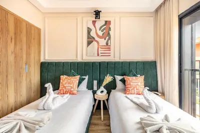 two beds in a room with a green headboard at Prestigia GOLF with Pool Bohemian Cocoon Stylish in Marrakech