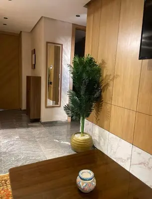 a lobby with a plant in a vase on a table at Apprt de haut-de-gamme a Jnane awrad in Marrakech