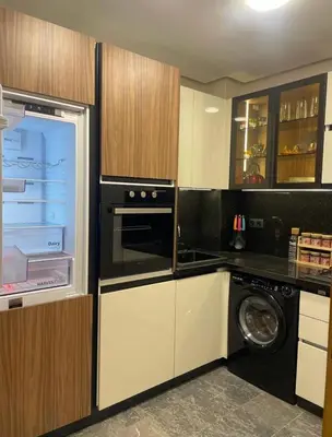 a kitchen with a washer and a washer and dryer at Apprt de haut-de-gamme a Jnane awrad in Marrakech