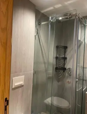 a shower with a glass door in a bathroom at Apprt de haut-de-gamme a Jnane awrad in Marrakech