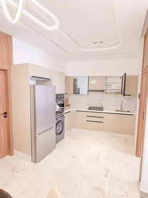 a kitchen with a refrigerator and a dishwasher at Studio haut standing in Marrakech