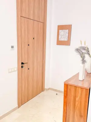 a wooden door in a room with a table at Studio haut standing in Marrakech