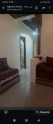 a bedroom with a bed and a couch in a room at Al andalous in Marrakech