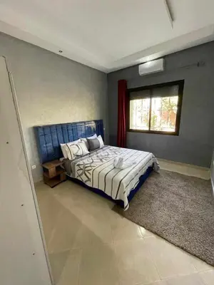 a bedroom with a large bed with a window at villa BASMA in Marrakech