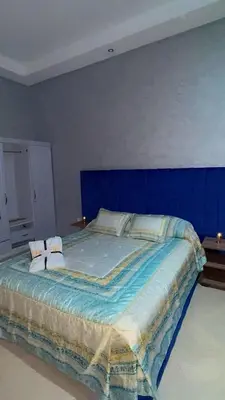 a blue bedroom with a bed with two pillows at villa BASMA in Marrakech