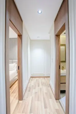 a hallway with a bathroom with a bed and a sink at Your Tiny Paradise - Marrakech - Prestigia in Marrakech