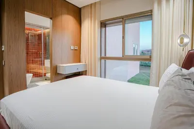 a bedroom with a white bed and a large window at Your Tiny Paradise - Marrakech - Prestigia in Marrakech