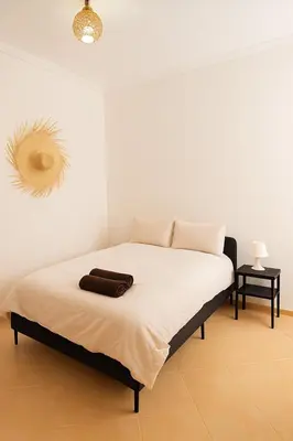 a bedroom with a bed with a brown bag on it at Cosy appartement 75m2 in Marrakech