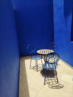 two chairs and a table and a table and chairs at Cosy appartement 75m2 in Marrakech