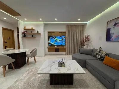 a living room with a couch and a tv at Chic 2BDR Apartment in Gueliz in Marrakech