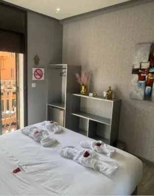 a bedroom with a white bed with towels on it at Mohsine in Marrakech
