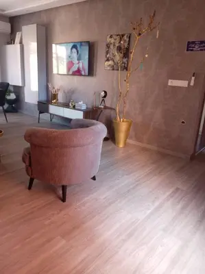 a living room with a chair and a table at Mohsine in Marrakech