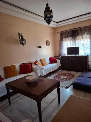 a living room with a couch and a table at Appartememt Hivernage 4 in Marrakech