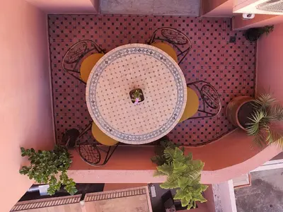 an overhead view of a table and chairs with plants at Appartememt Hivernage 4 in Marrakech