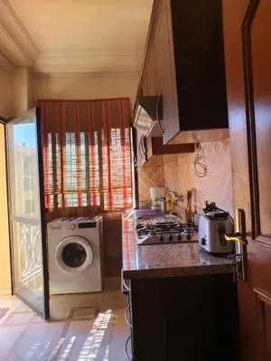 a kitchen with a washing machine and a washer at Appartememt Hivernage 4 in Marrakech