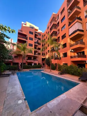 a swimming pool in front of an apartment building at Studio Rolex Guéliz, situé à seulement 5 minutes de la place Jemaa El-Fna in Marrakech