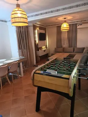 a living room with a foosball table at Appartement Marrakech gueliz climatisé avec piscine et baby foot in Marrakech