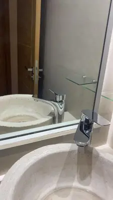 a bathroom sink with a mirror and a faucet at Appartement Marrakech gueliz climatisé avec piscine et baby foot in Marrakech