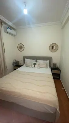 a bedroom with a large white bed in a room at Appartement Marrakech gueliz climatisé avec piscine et baby foot in Marrakech