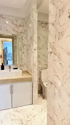 a bathroom with a sink and a mirror and a toilet at Honey home Marrakech in Marrakech