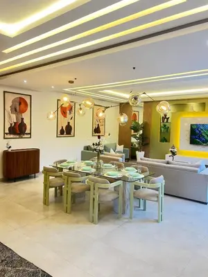 a dining room with a table and a couch at Villa Elixir , Luxury residence , private pool in El Rhechat