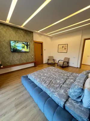 a large bedroom with a blue bed in a room at Villa Elixir , Luxury residence , private pool in El Rhechat