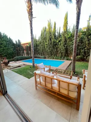 a view of a pool from the patio of a house at Villa Elixir , Luxury residence , private pool in El Rhechat