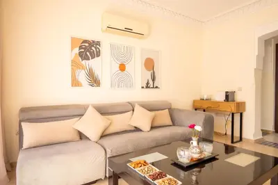 a living room with a couch and a table at Luxury 2 BDRM in Hivernage with Pool and Garden in Marrakech
