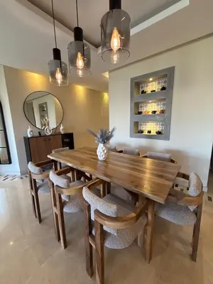 a dining room with a wooden table and chairs at Prestigia Pool 5 min Airport in Marrakech