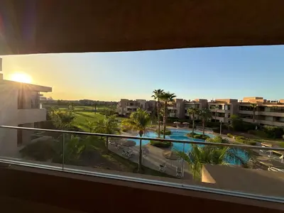 a view of a pool from a balcony of a building at Prestigia Pool 5 min Airport in Marrakech