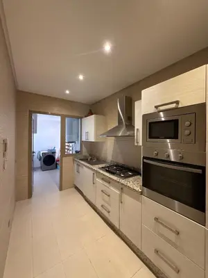 a kitchen with a stove and a microwave at Prestigia Pool 5 min Airport in Marrakech