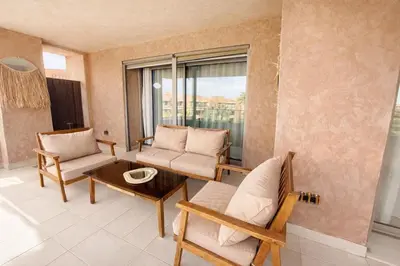 a living room with two chairs and a table at Prestigia Pool 5 min Airport in Marrakech
