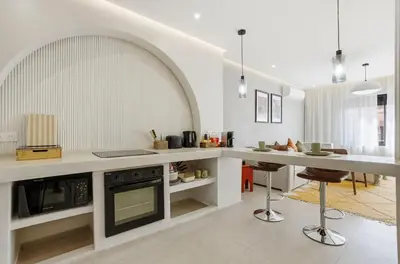 an open kitchen with a counter and a stove at Cosy Modern Apartment Central Gueliz Marrakech in Marrakech