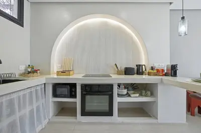 a kitchen with a counter top with a microwave at Cosy Modern Apartment Central Gueliz Marrakech in Marrakech