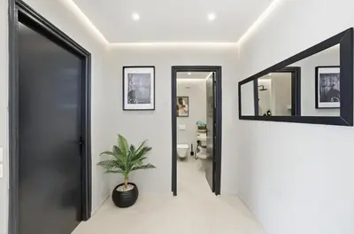 a hallway with a toilet and a potted plant at Cosy Modern Apartment Central Gueliz Marrakech in Marrakech