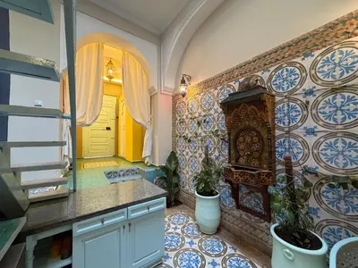 a kitchen with blue and white tiles on the wall at La Petite Maison by Riad Dar Saad- Dar El Bacha in Marrakech