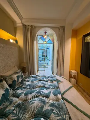 a bedroom with a bed and a window and a window sidx sidx at La Petite Maison by Riad Dar Saad- Dar El Bacha in Marrakech