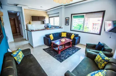 a living room with couches and a table at Appartement moderne Guéliz, Centre Marrakech in Marrakech