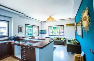 a large living room with a bar and a couch at Appartement moderne Guéliz, Centre Marrakech in Marrakech