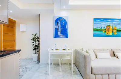 a living room with a couch and a table at Cosy studio au cœur de Marrakech in Marrakech