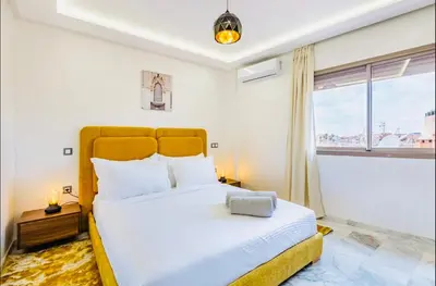 a bedroom with a large bed and a window at Cosy studio au cœur de Marrakech in Marrakech