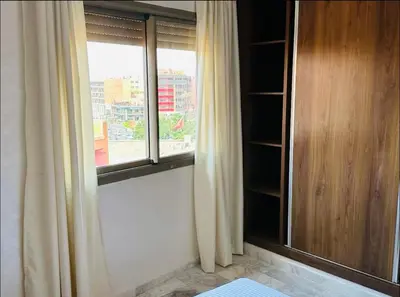 a room with a window with a view of a city at Cosy studio au cœur de Marrakech in Marrakech