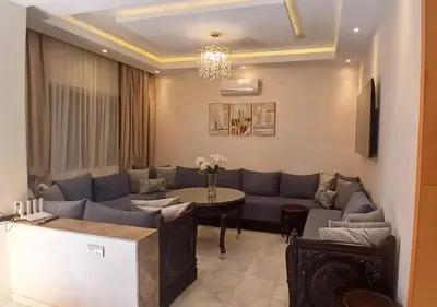 a living room with a couch and a table at Villa Élégance Familiale in Marrakech