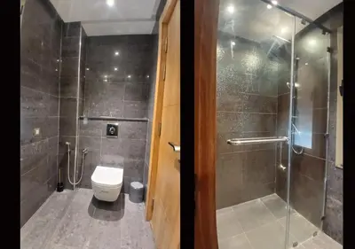 a bathroom with a shower and a toilet and a glass door at Villa Élégance Familiale in Marrakech