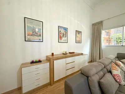 a living room with a couch and a desk at Duplex Majorelle avec Jardin et Parking in Marrakech